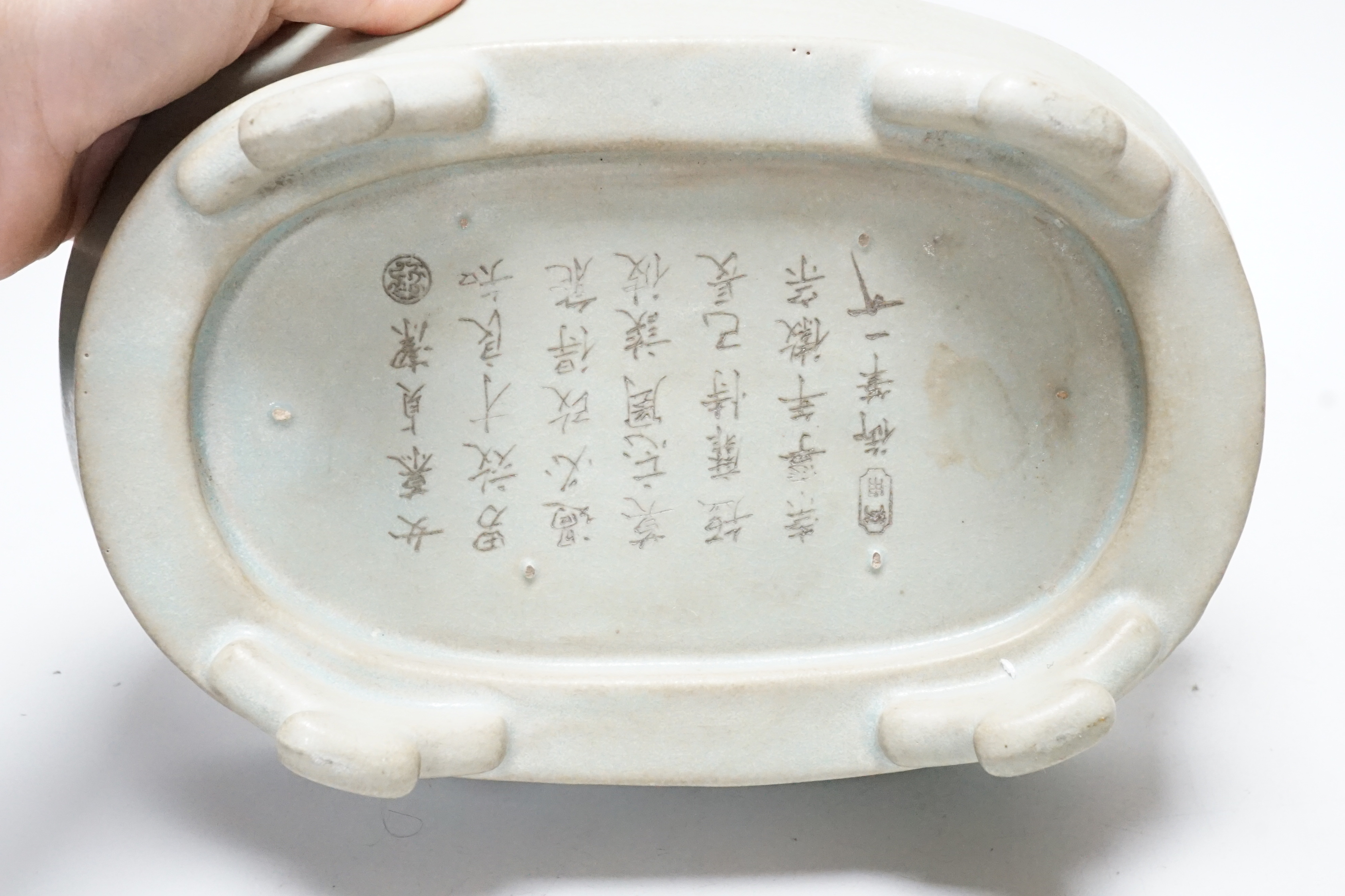 A Chinese celadon glazed dish and another, largest 24cm